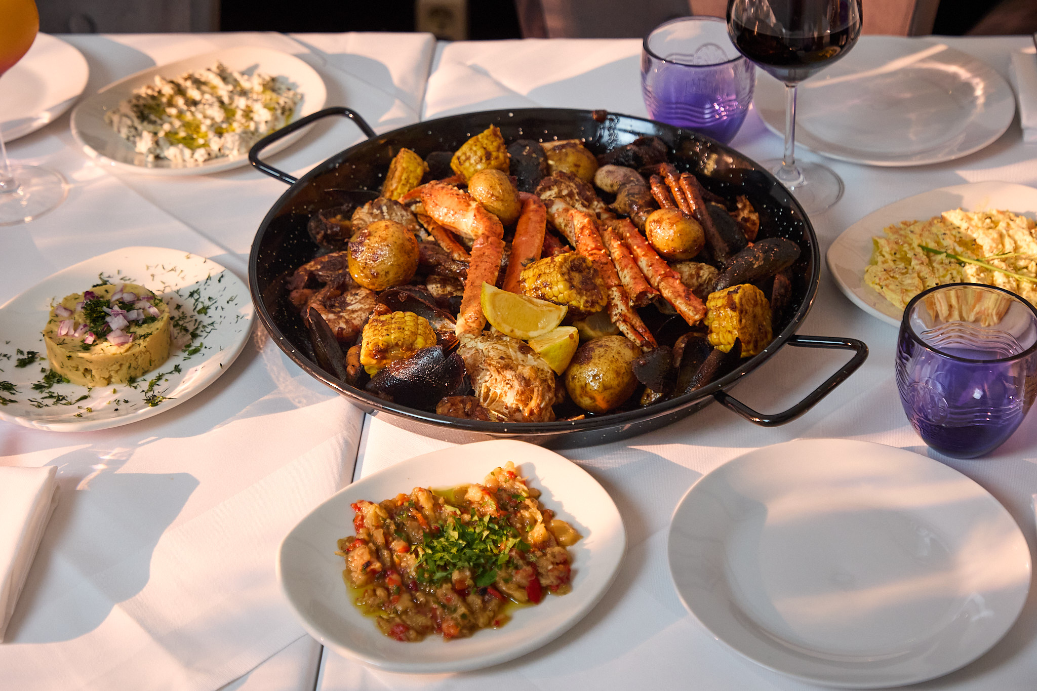 Seafood Boil bei MAVISU: Krustentiere, Garnelen, Muscheln, Mais und Babykartoffeln in der Pfanne